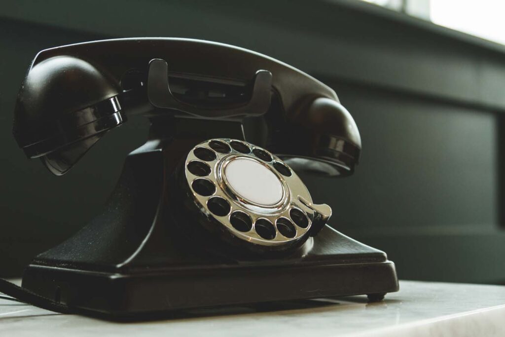 Vintage black rotary phone to symbolize how people can get in touch to place an order.